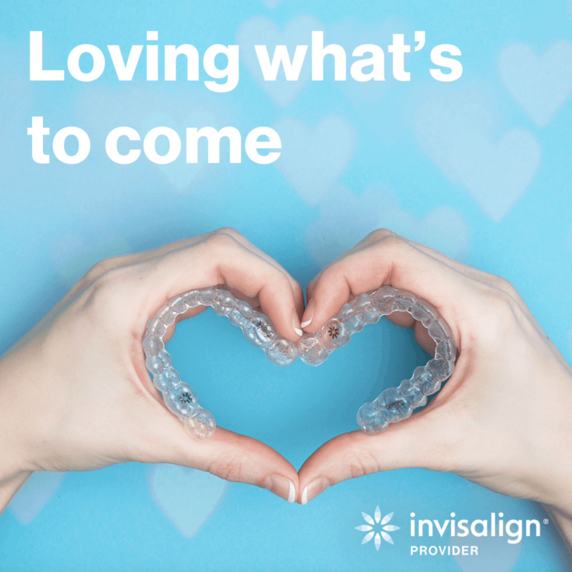 Patient holding Invisalign clear aligners in the shape of a heart, representing a confident smile and clear aligner treatment at Longmont Peak Dentistry in Longmont, CO.